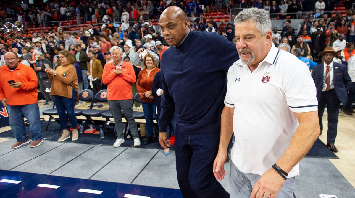 Former Auburn basketball player Charles Barkley and Auburn Tigers head coach Bruce Pearl take the court after the game as Auburn Tigers take on USC Trojans at Neville Arena