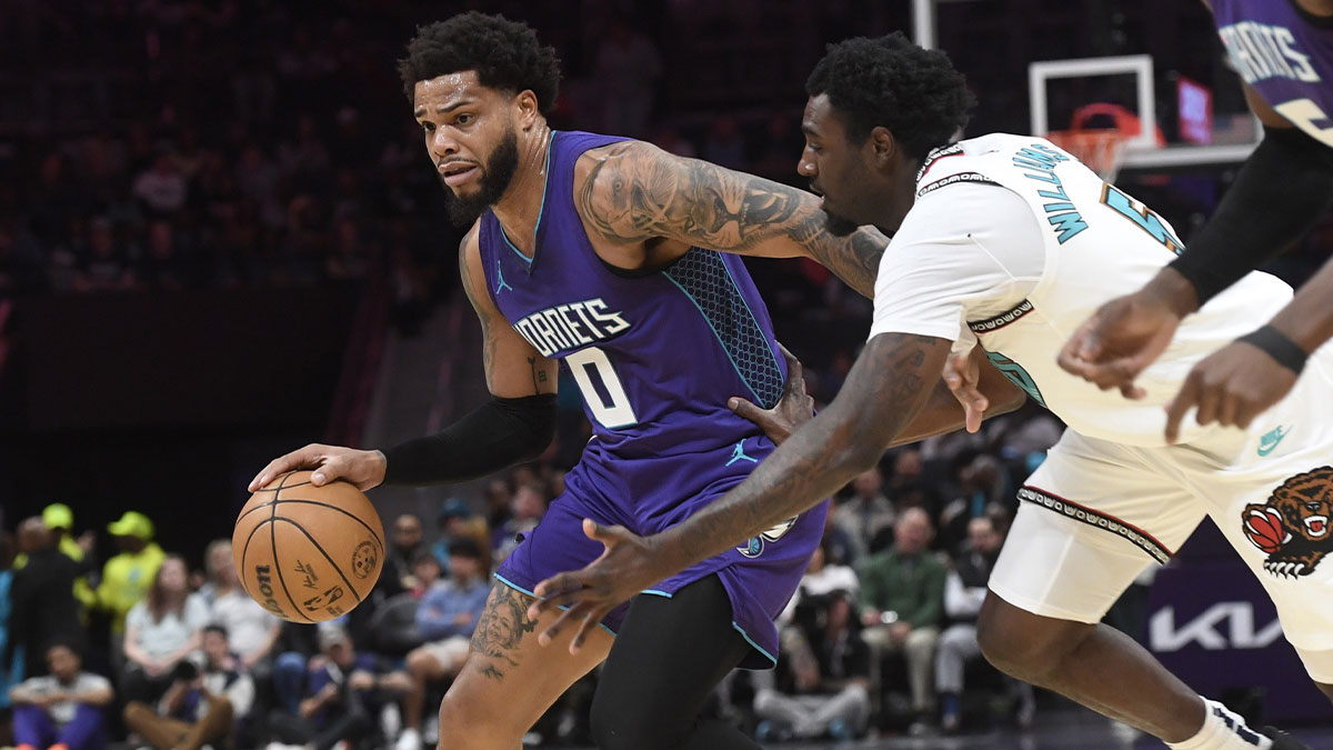 Charlotte Hornets forward Miles Bridges (0) drives past Memphis Grizzlies guard forward Vince Williams Jr. (5) during the first half at the Spectrum Center.