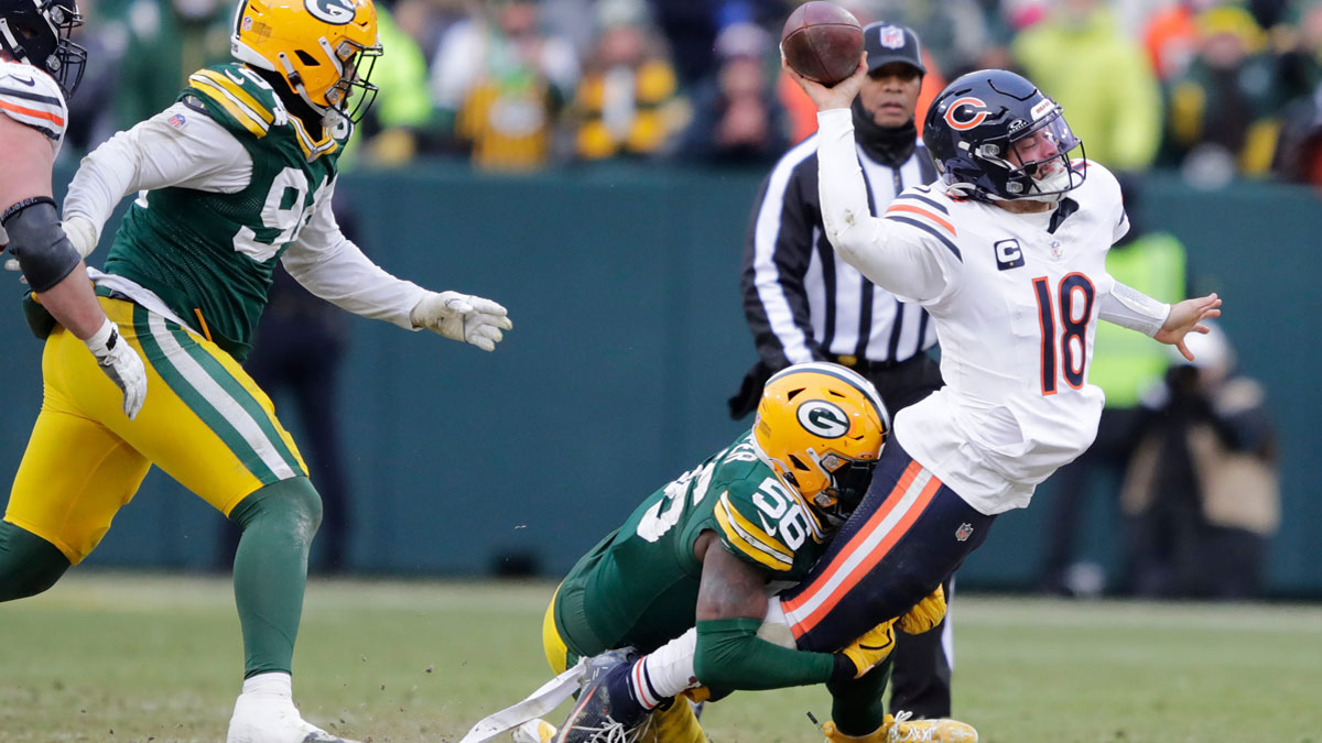 Chicago Bears quarterback Caleb Williams (18) throws an incomplete pass as he is tackled by Green Bay Packers linebacker Edgerrin Cooper (56) in the fourth quarter during their football game.