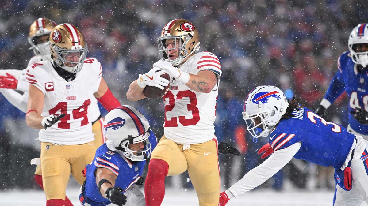 San Francisco 49ers running back Christian McCaffrey (23) is tackled by Buffalo Bills safety Taylor Rapp (9) and safety Damar Hamlin (3) in the second quarter at Highmark Stadium.