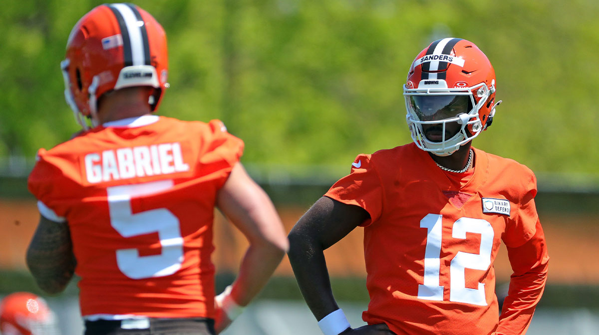 Cleveland Browns quarterback Shedeur Sanders (12) watches quarterback Dillon Gabriel (5) during day two of NFL rookie minicamp at the Cleveland Browns training facility on Saturday, May 10, 2025, in Berea, Ohio.