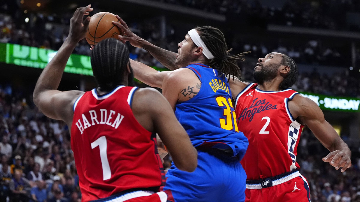 LA Clippers guard James Harden (1) and LA Clippers forward Kawhi Leonard (2) defend on forward Aaron Gordon (32) in the second quarter during game seven of first round for the 2025 NBA Playoffs at Ball Arena.