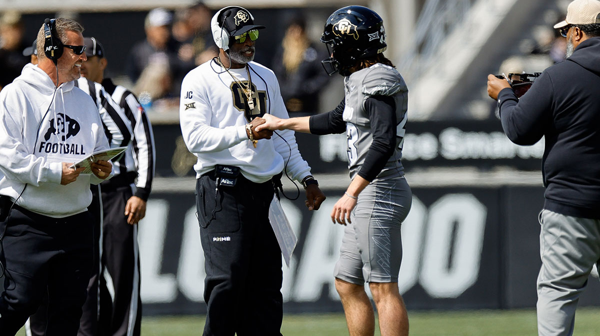 Colorado Buffaloes head coach Deion Sanders and place kicker Buck Buchanan (43) during the spring game at Folsom Field.