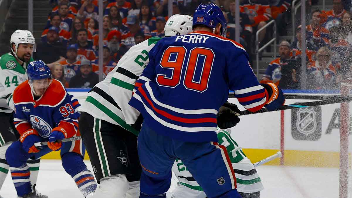 Dallas Stars center Roope Hintz (24) and Edmonton Oilers right wing Corey Perry (90) crash into the net during the first period in game four of the Western Conference Final of the 2025 Stanley Cup Playoffs at Rogers Place.