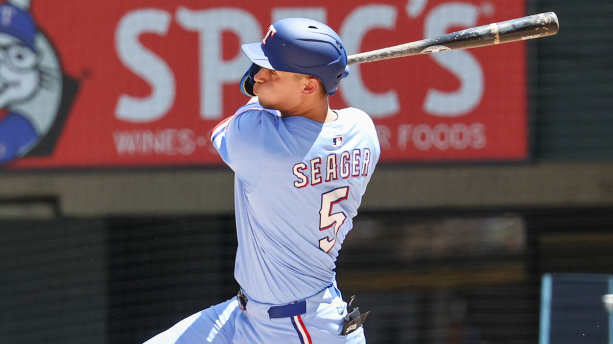May 4, 2025; Arlington, Texas, USA; Texas Rangers shortstop Corey Seager (5) hits a two-run single during the third inning against the Seattle Mariners at Globe Life Field.