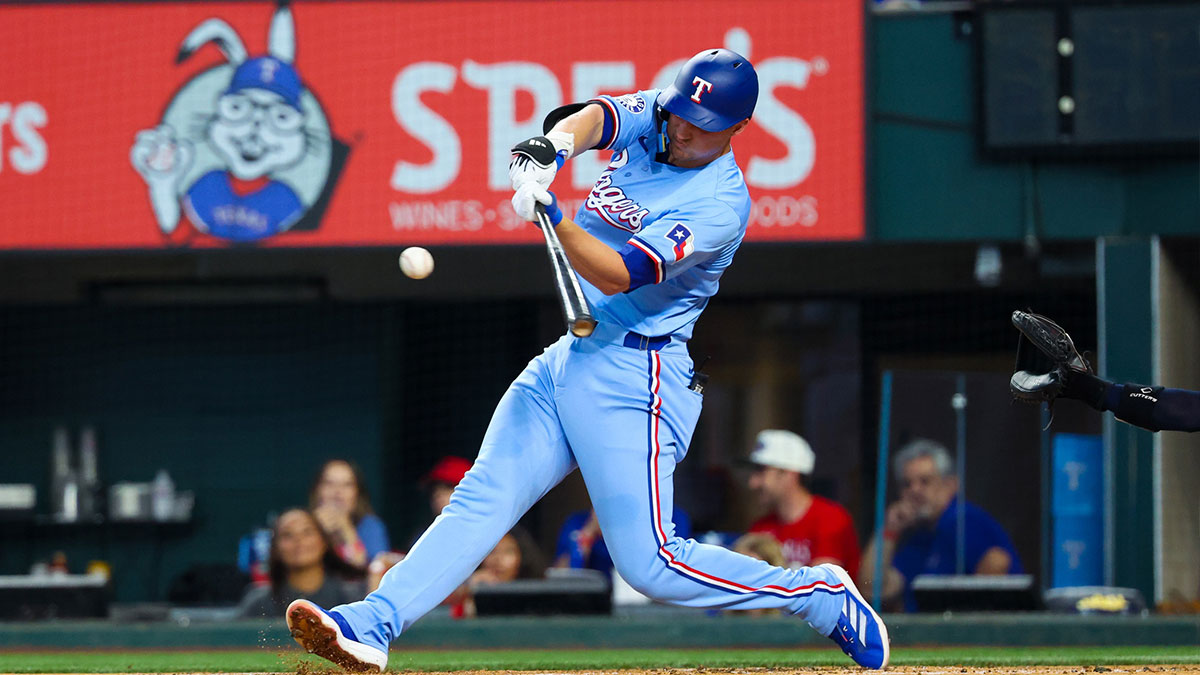 Aug 4, 2024; Arlington, Texas, USA; Texas Rangers shortstop Corey Seager (5) hits a home run during the first inning against the Boston Red Sox at Globe Life Field.