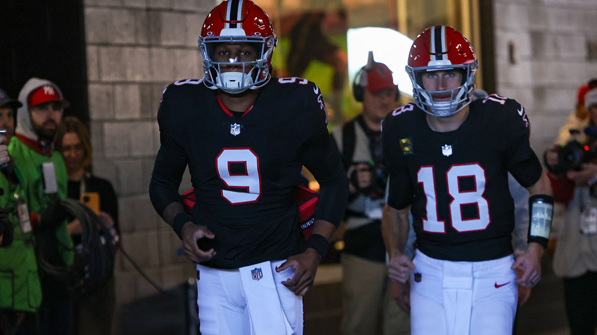 Atlanta Falcons quarterback Michael Penix Jr. (9) and quarterback Kirk Cousins (18) run on the field before a game against the New York Giants at Mercedes-Benz Stadium.