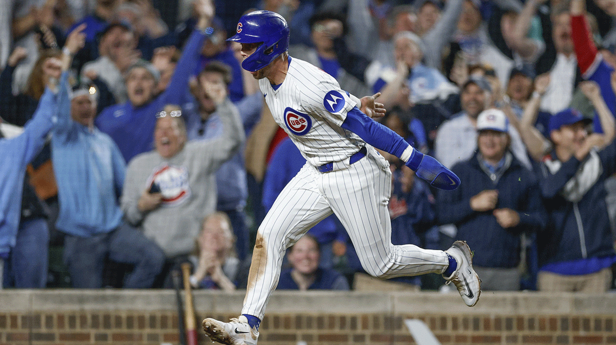 Chicago Cubs second baseman Nico Hoerner (2) runs to score on a walk-off two-run double hit by first baseman Justin Turner (not pictured) against the Miami Marlins during the ninth inning at Wrigley Field.