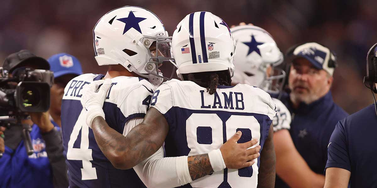 Dallas Cowboys wide receiver CeeDee Lamb (88) and quarterback Dak Prescott (4) talk during the game against the Washington Commanders.
