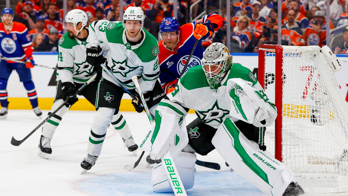 Edmonton Oilers right wing Corey Perry (90) skates between Dallas Stars defenseman Esa Lindell (23) and goaltender Jake Oettinger (29) during the third period in game four of the Western Conference Final of the 2025 Stanley Cup Playoffs at Rogers Place