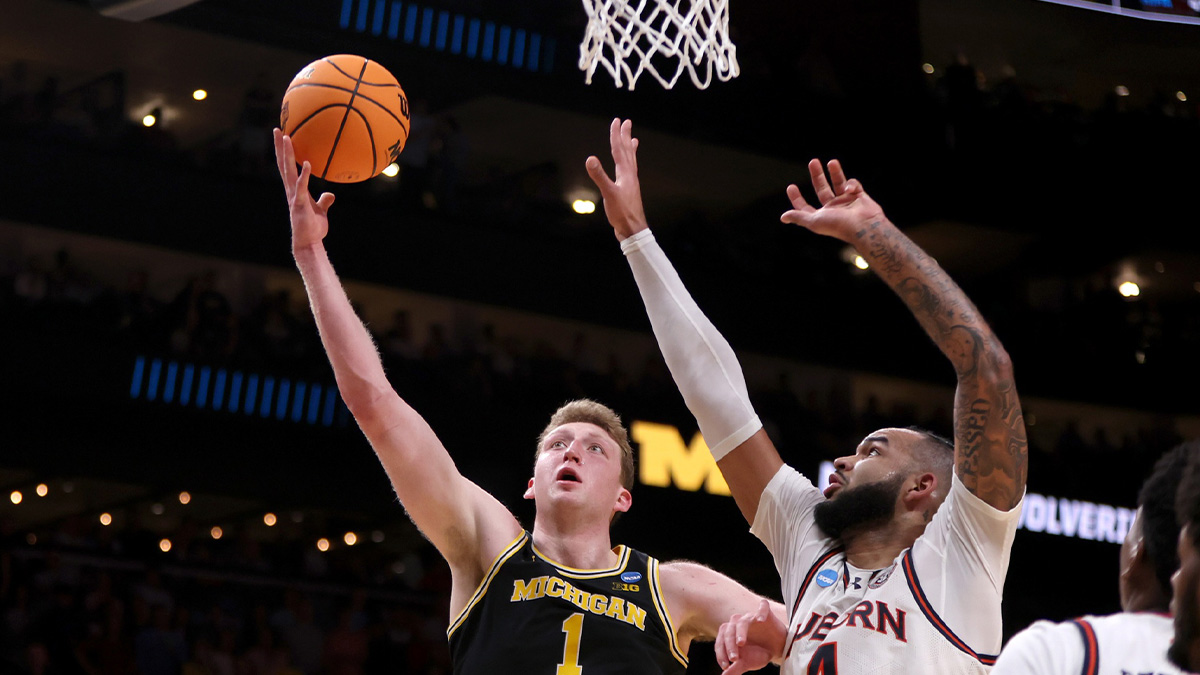 Michigan Wolverines center Danny Wolf (1) shoots against Auburn Tigers forward Johni Broome (4) in the second half of a South Regional semifinal of the 2025 NCAA tournament at State Farm Arena.