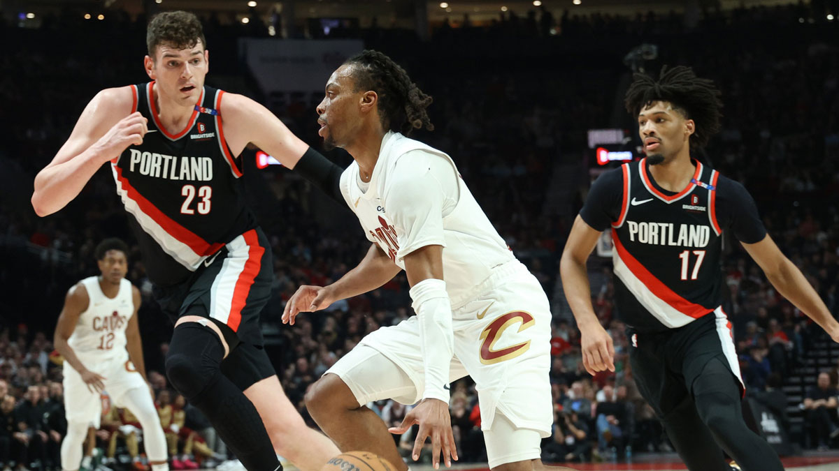 Cleveland Cavaliers guard Darius Garland (10) dribbles the ball past Portland Trail Blazers center Donovan Clingan (23) and Trail Blazers’ guard Shaedon Sharpe (17) in the first half at Moda Center.