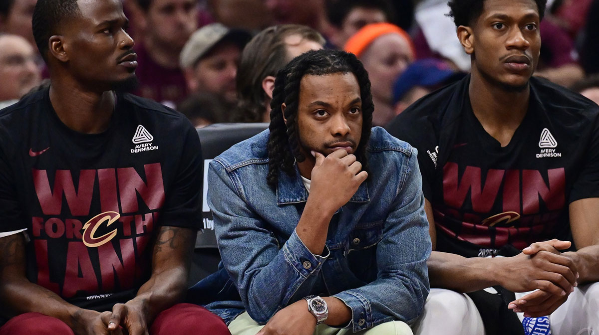 Cleveland Cavaliers guard Darius Garland, middle, watches from the bench during the first half against the Indiana Pacers in game one of the second round for the 2025 NBA Playoffs at Rocket Arena.