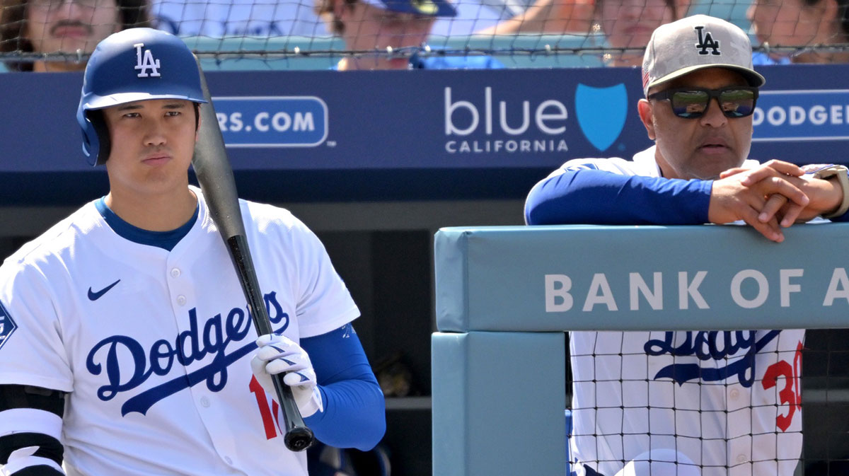 Los Angeles Dodgers designated hitter Shohei Ohtani (17) and manager Dave Roberts (30) look on from the dugout in the seventh inning against the Los Angeles Angels at Dodger Stadium.