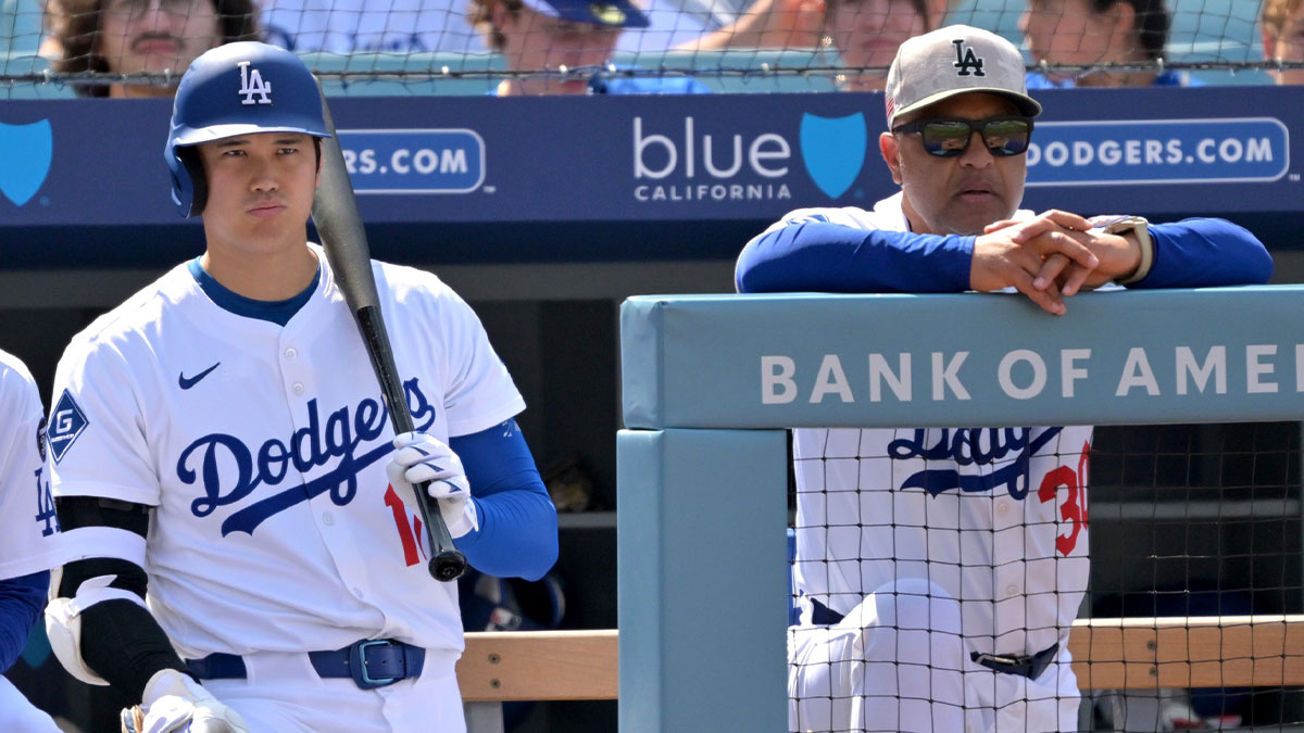 Los Angeles Dodgers designated hitter Shohei Ohtani (17) and manager Dave Roberts (30) look on from the dugout in the seventh inning against the Los Angeles Angels at Dodger Stadium.