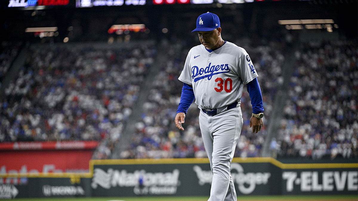 Los Angeles Dodgers manager Dave Roberts (30) walks back to the dugout during the eighth inning against the Texas Rangers at Globe Life Field.