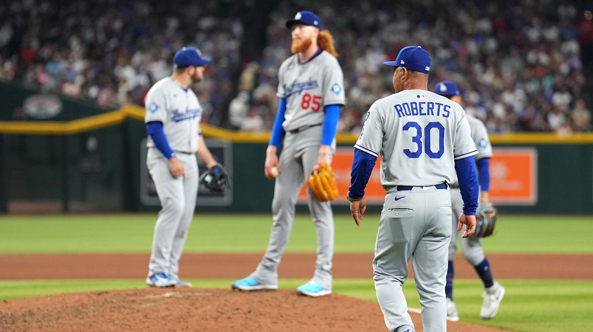 Los Angeles Dodgers pitcher Dustin May (85) is taken out of the game by Los Angeles Dodgers manager Dave Roberts (30) against the Arizona Diamondbacks during the seventh inning at Chase Field.