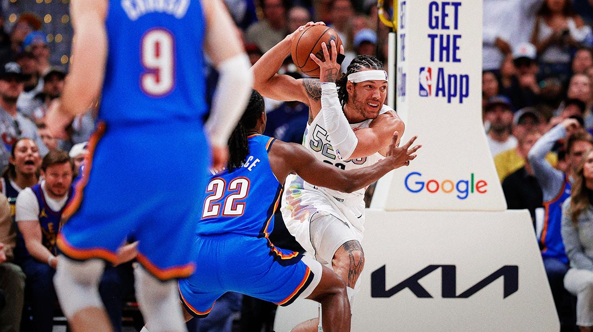 Denver Nuggets forward Aaron Gordon (32) controls the ball under pressure from Oklahoma City Thunder guard Cason Wallace (22) as guard Alex Caruso (9) looks on in the fourth quarter during game six of the second round for the 2025 NBA Playoffs at Ball Arena.