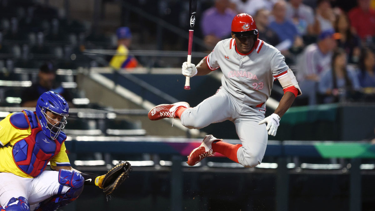 Canada batter Denzel Clarke reacts after being hit by a pitch in front of Colombia catcher Elias Diaz in the fifth inning during the World Baseball Classic at Chase Field.