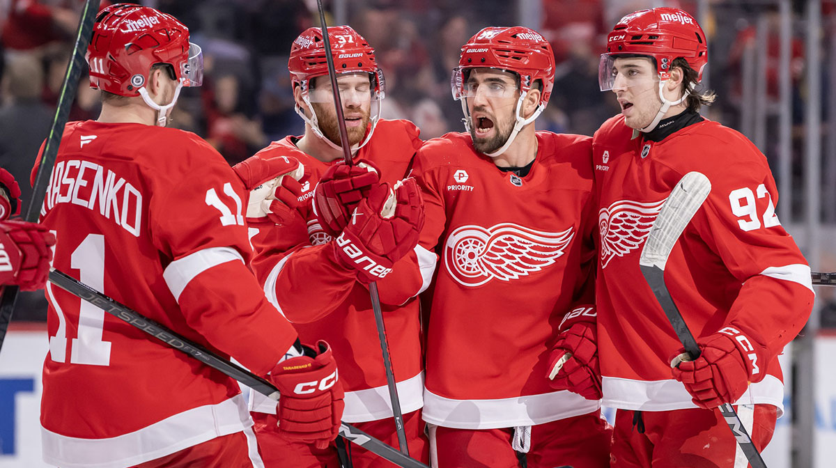 Detroit Red Wings defenseman Erik Gustafsson (56) celebrates his power play goal against the Seattle Kraken with forward Vladimir Tarasenko (11), forward J.T. Compher (37), and forward Marco Kasper (92) during the second period at Little Caesars Arena.