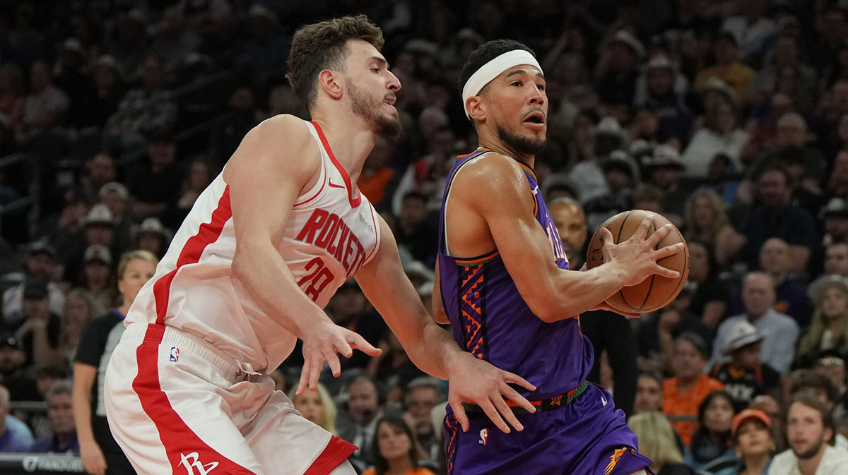 Phoenix Suns guard Devin Booker (1) drives past Houston Rockets center Alperen Sengun (28) in the first half at Footprint Center.