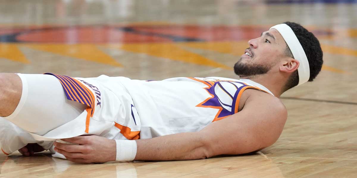 Phoenix Suns guard Devin Booker (1) reacts after making a basket and being fouled against the San Antonio Spurs during the second half at Footprint Center.