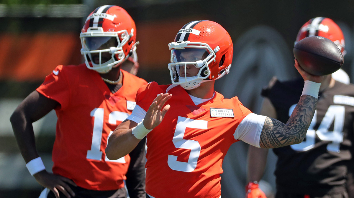 Cleveland Browns quarterback Dillon Gabriel (5) throws as quarterback Shedeur Sanders (12) looks on during NFL rookie minicamp at the Cleveland Browns training facility on Friday, May 9, 2025, in Berea, Ohio.