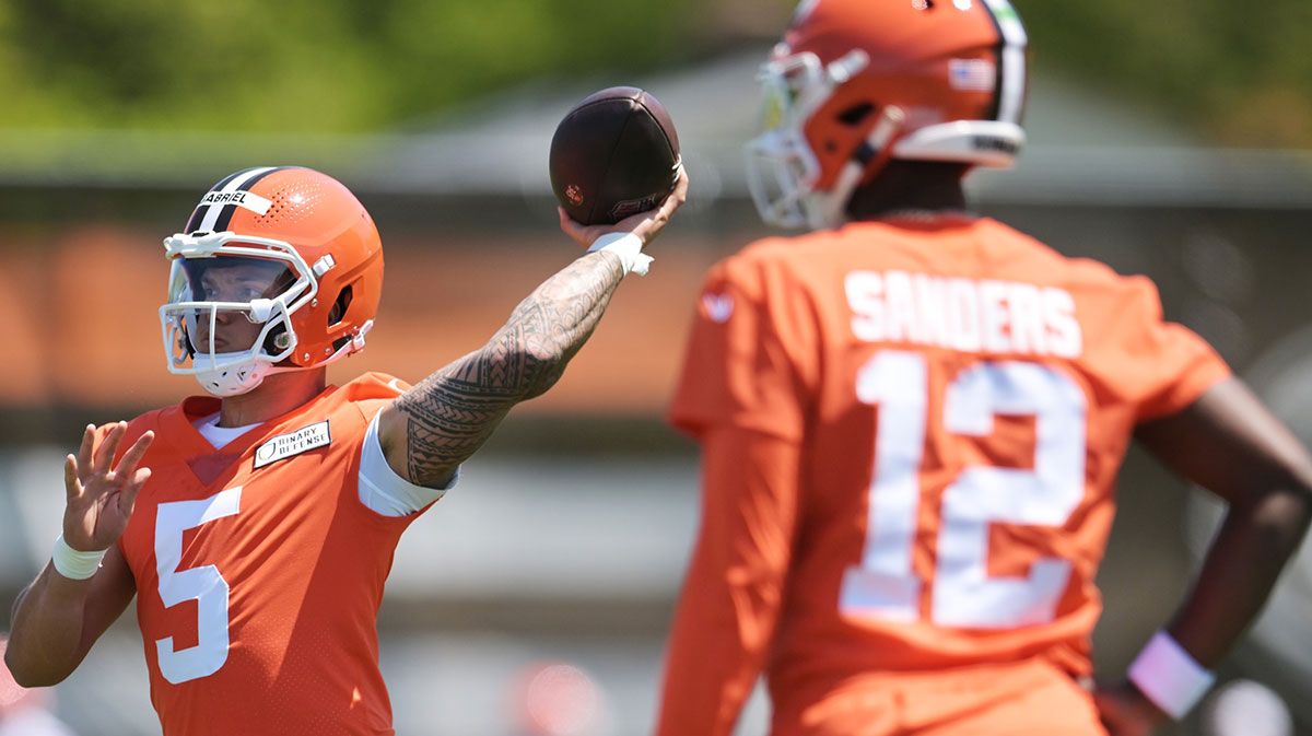 Cleveland Browns quarterback Dillon Gabriel (5) passes as quarterback Shedeur Sanders (12) looks on during rookie minicamp at CrossCountry Mortgage Campus.