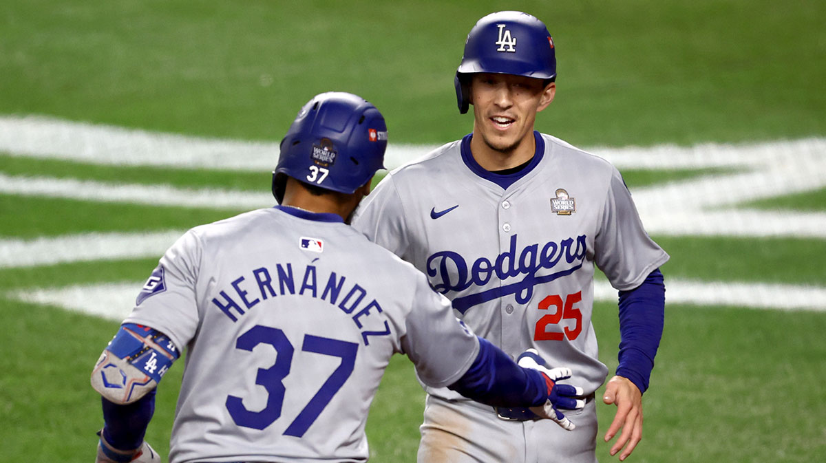 Los Angeles Dodgers outfielder Tommy Edman (25) celebrates with outfielder Teoscar Hernandez (37) after scoring during the third inning in game three of the 2024 MLB World Series against the New York Yankees at Yankee Stadium.