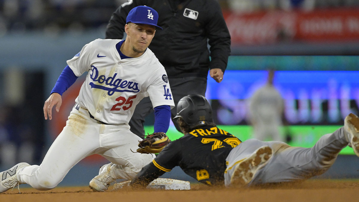 Los Angeles Dodgers second baseman Tommy Edman (25) tags Pittsburgh Pirates second baseman Adam Frazier (26) on a stolen base attempt in the sixth at Dodger Stadium.