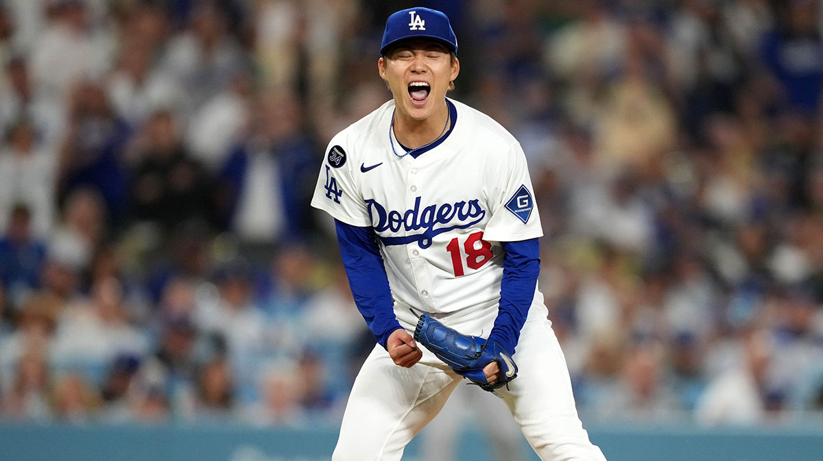 Los Angeles Dodgers starting pitcher Yoshinobu Yamamoto (18) celebrates at the end of the seventh inning against the Arizona Diamondbacks at Dodger Stadium.
