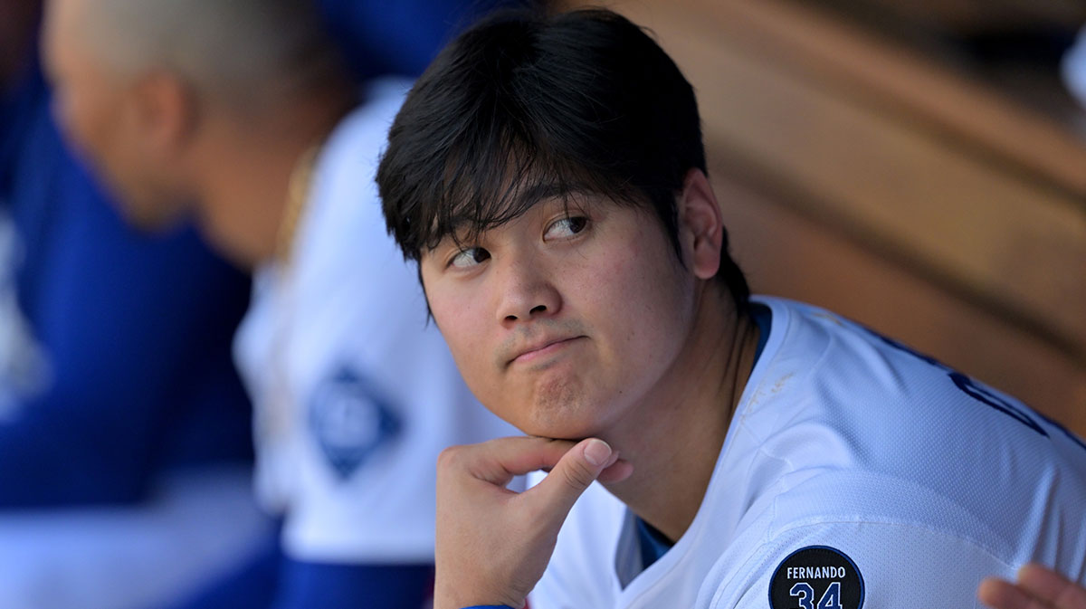 Los Angeles Dodgers designated hitter Shohei Ohtani (17) looks on from the dugout against the Los Angeles Angels at Dodger Stadium.