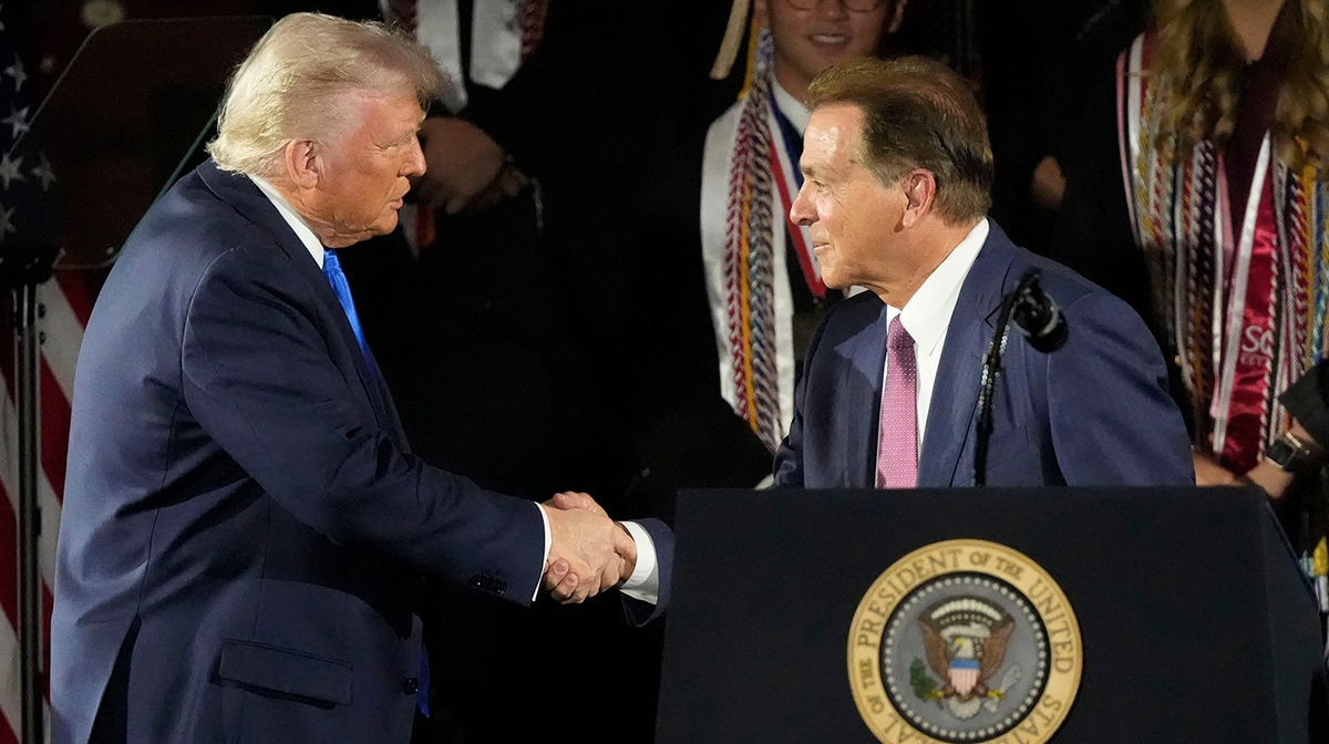 President Donald Trump shakes hands with legendary Alabama football coach Nick Saban before delivering a special commencement address to University of Alabama graduates at Coleman Coliseum on May 1, 2025. Graduation occurs over the weekend.