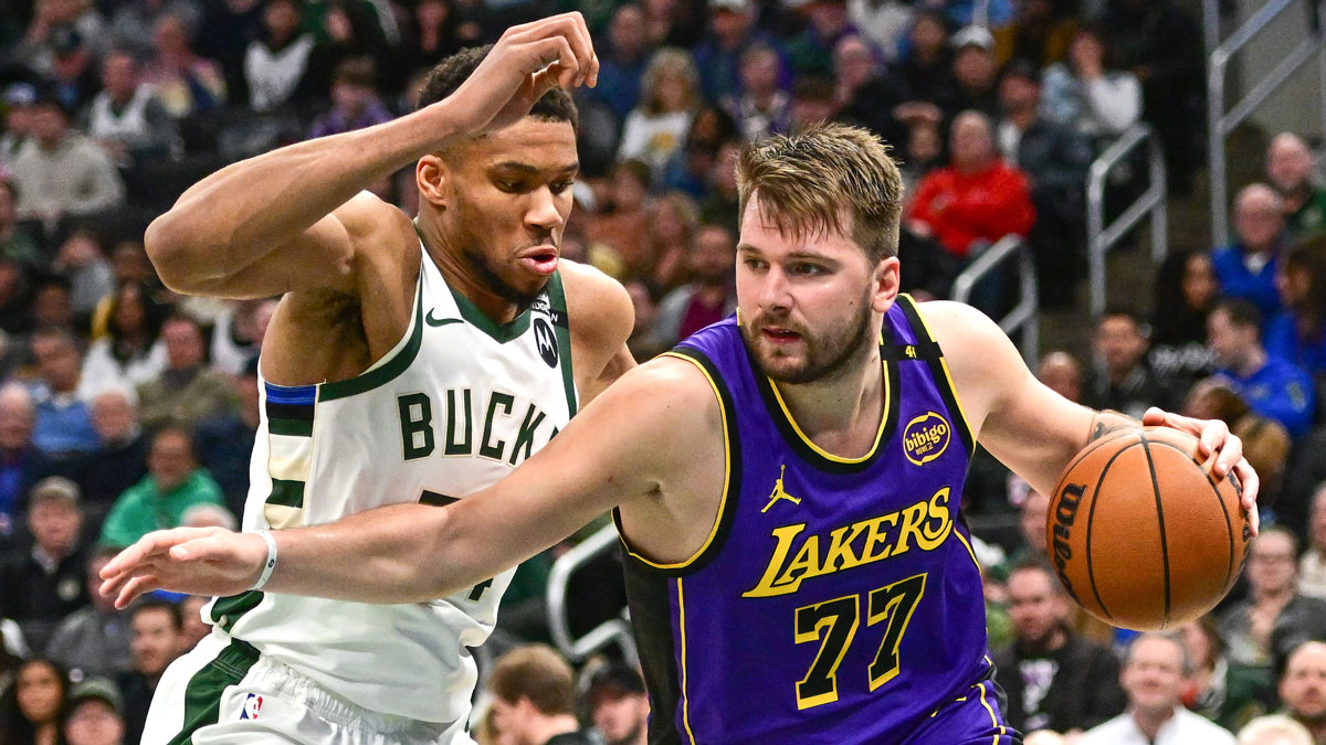 Los Angeles Lakers guard Luka Doncic (77) drives to the basket against Milwaukee Bucks forward Giannis Antetokounmpo (34) in the third quarter at Fiserv Forum.