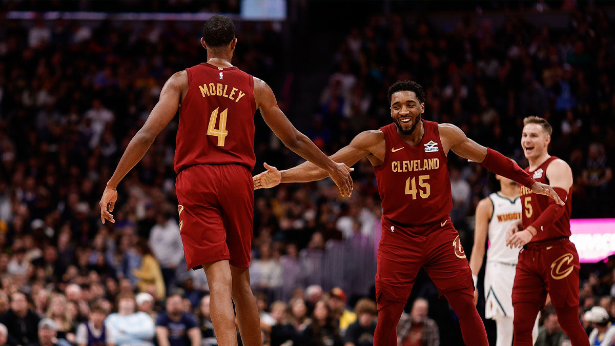 Cleveland Cavaliers guard Donovan Mitchell (45) reacts with forward Evan Mobley (4) after a play in the fourth quarter against the Denver Nuggets at Ball Arena.