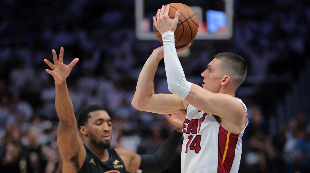 Miami Heat guard Tyler Herro (14) shoots the basketball over Cleveland Cavaliers guard Donovan Mitchell (45) in the first quarter during game four for the first round of the 2025 NBA Playoffs at Kaseya Center.