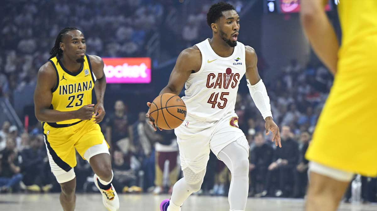 Cleveland Cavaliers guard Donovan Mitchell (45) brings the ball up court beside Indiana Pacers forward Aaron Nesmith (23) in the first quarter during game two of the second round of the 2025 NBA Playoffs at Rocket Arena.