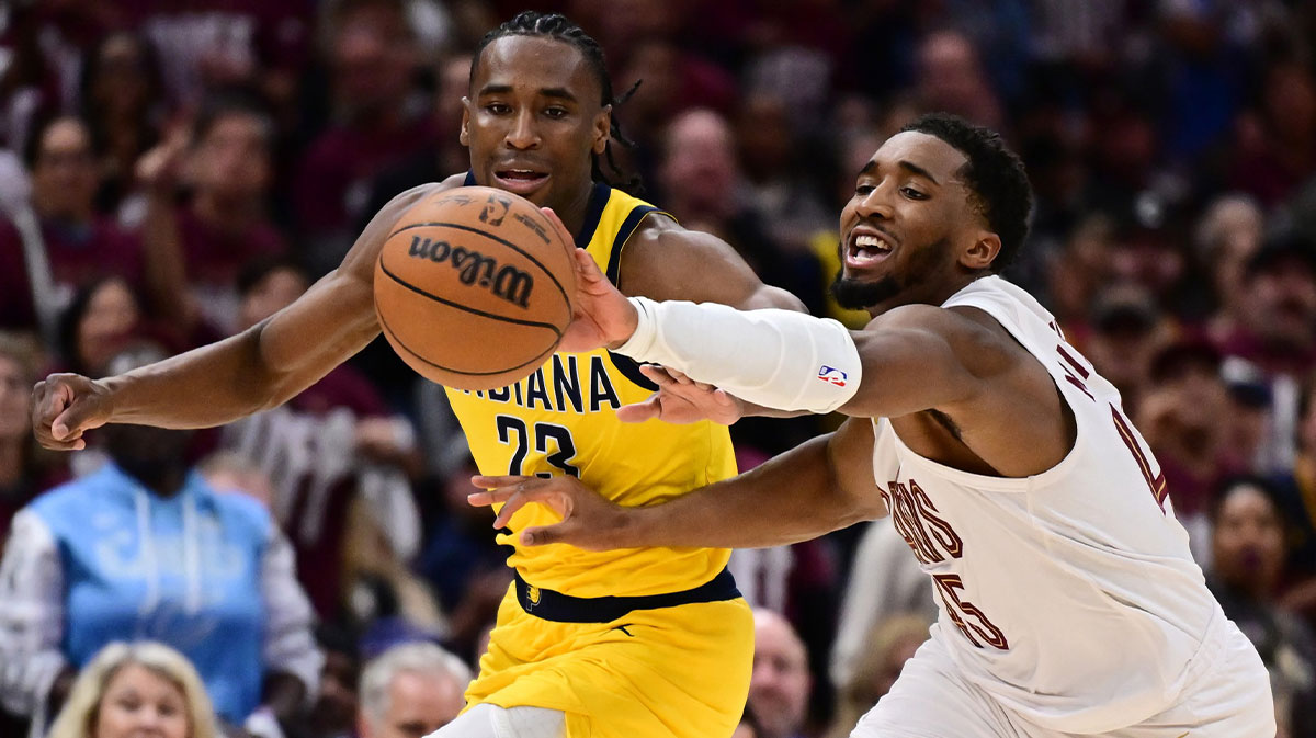 Cleveland, Ohio, USA; Cleveland Cavaliers guard Donovan Mitchell (45) goes for a loose ball against Indiana Pacers forward Aaron Nesmith (23) during the second half in game one of the second round for the 2025 NBA Playoffs at Rocket Arena. The Cavs lost Game 1.