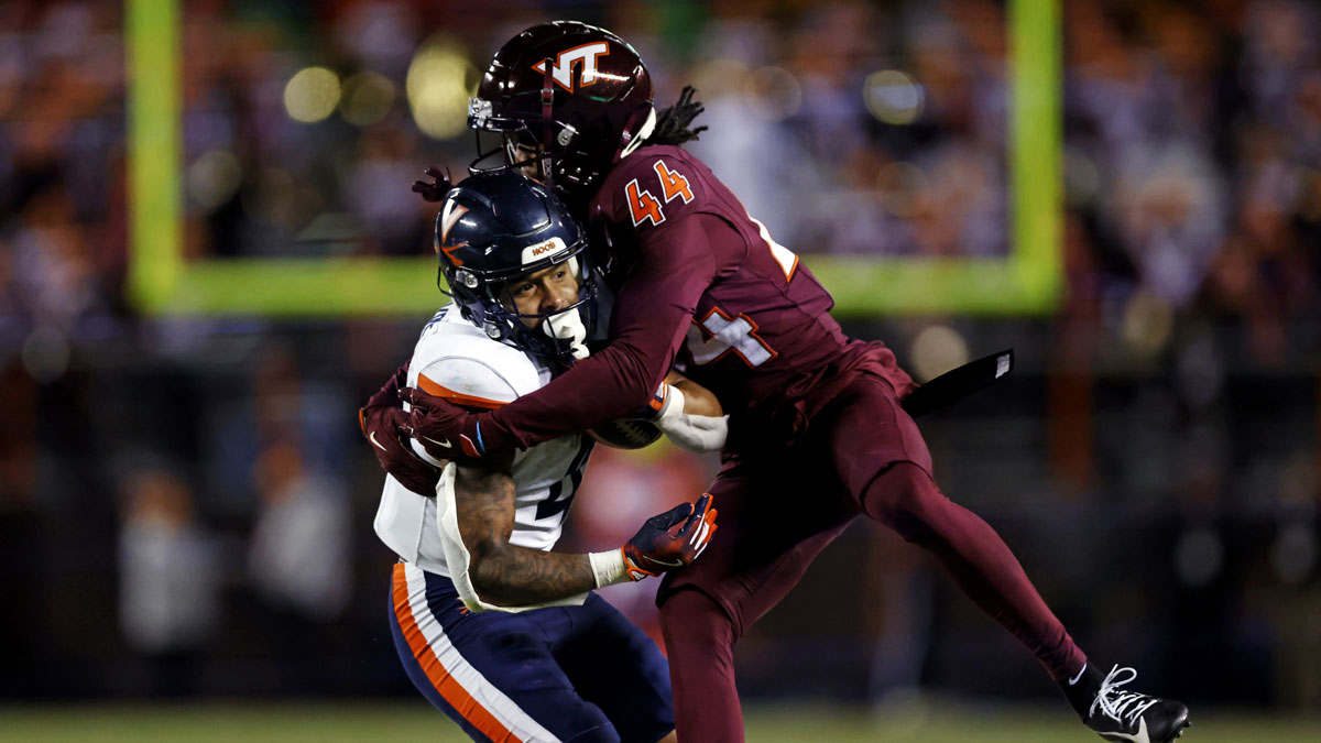 Virginia Tech Hokies cornerback Dorian Strong (44) tackles Virginia Cavaliers wide receiver Chris Tyree (4) during the fourth quarter at Lane Stadium.