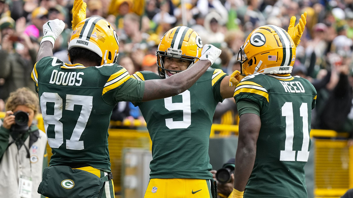 Oct 13, 2024; Green Bay, Wisconsin, USA; Green Bay Packers wide receiver Romeo Doubs (87) celebrates with wide receivers Christian Watson (9) and Jayden Reed (11) after scoring a touchdown during the third quarter against the Arizona Cardinals at Lambeau Field. Mandatory Credit: Jeff Hanisch-Imagn Images