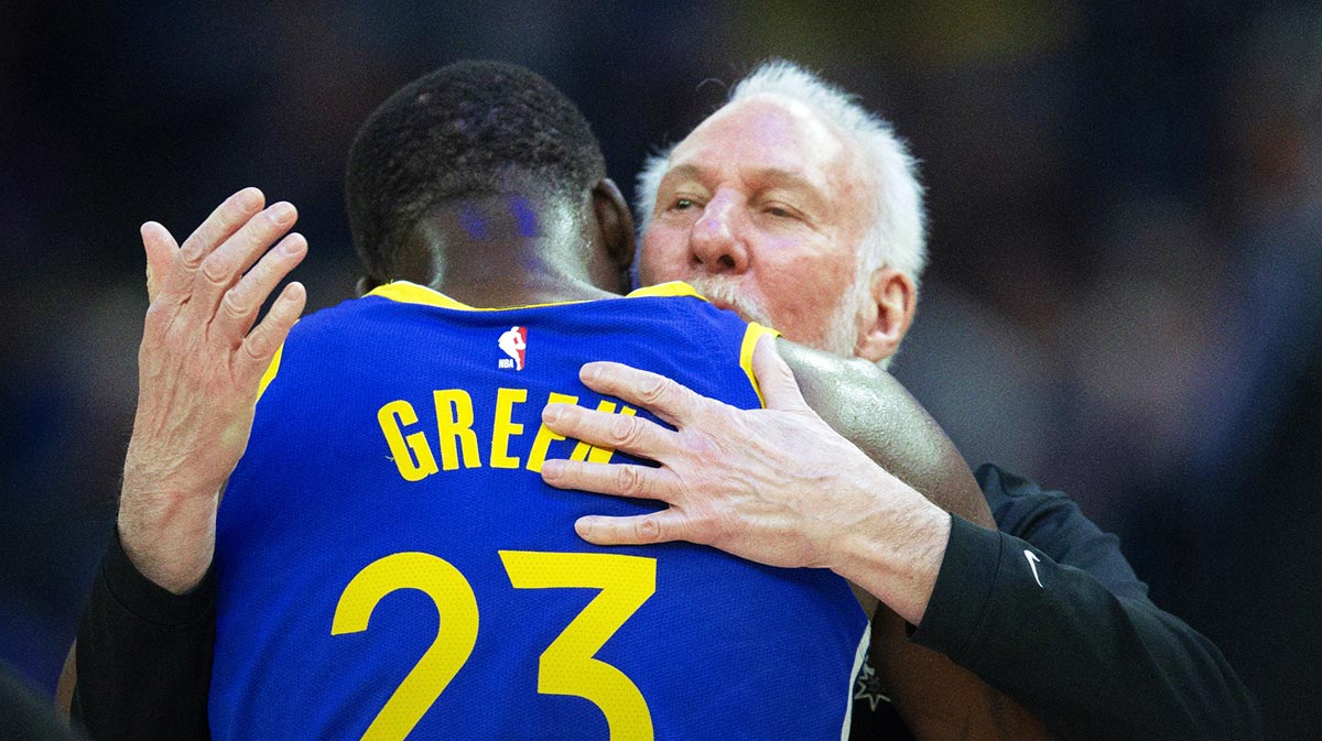 San Antonio Spurs head coach Gregg Popovich (right) embraces Golden State Warriors forward Draymond Green (23) during a timeout in the first quarter at Chase Center.