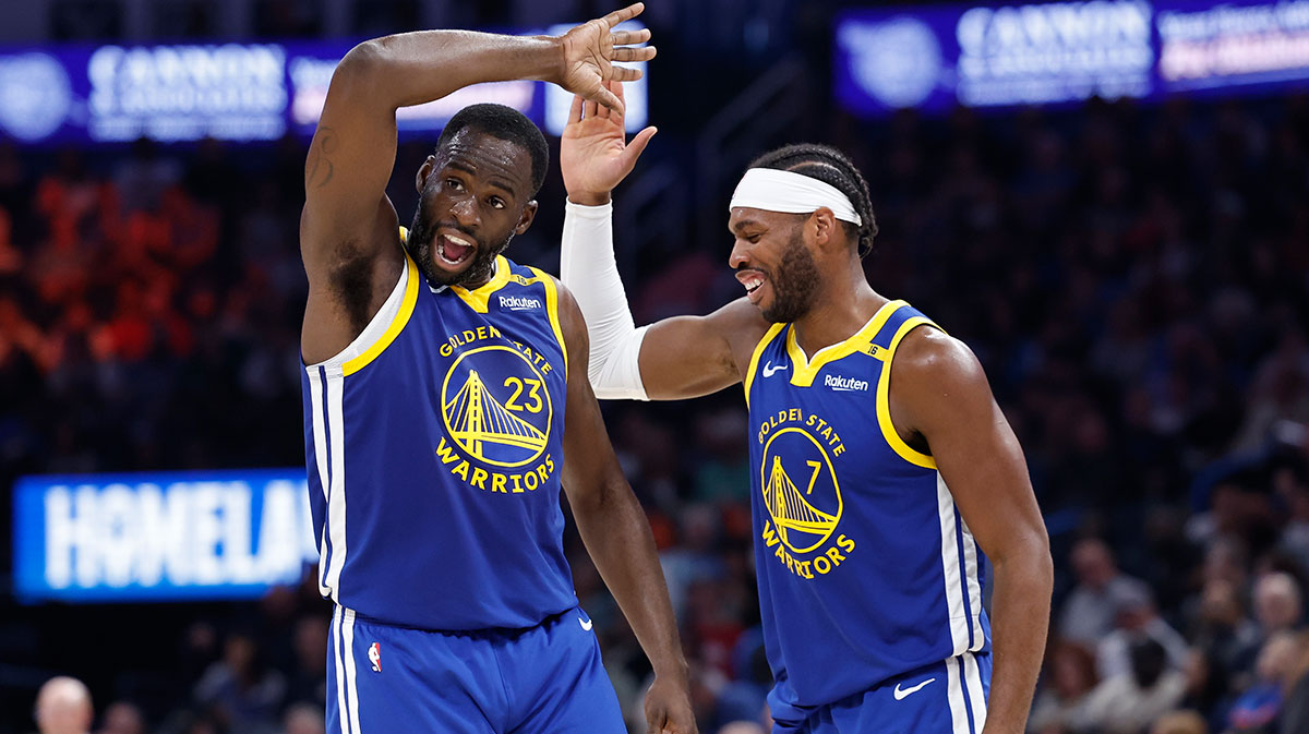 Golden State Warriors forward Draymond Green (23) and guard Buddy Hield (7) celebrate after their team scores against the Oklahoma City Thunder during the second half at Paycom Center.