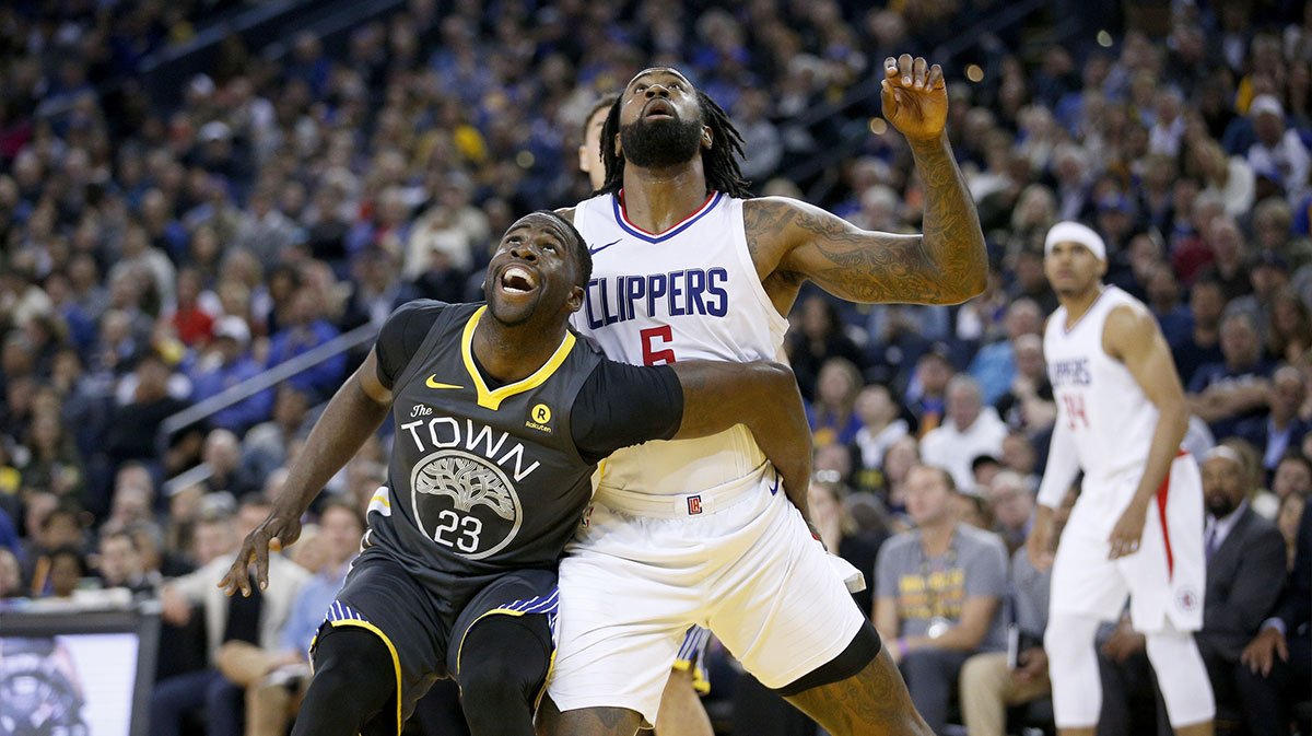 Golden State Warriors forward Draymond Green (23) and Los Angeles Clippers center DeAndre Jordan (6) battle for position in the second quarter at Oracle Arena.