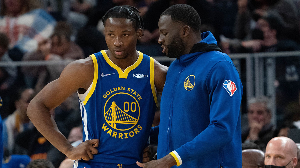 Golden State Warriors forward Jonathan Kuminga (00) listens to forward Draymond Green (23) during the fourth quarter against the Oklahoma City Thunder at Chase Center.