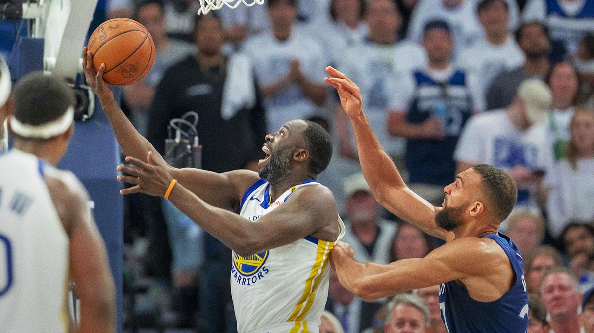 Golden State Warriors forward Draymond Green (23) drives to the basket past Minnesota Timberwolves center Rudy Gobert (27) in the first half during game five of the second round for the 2025 NBA Playoffs at Target Center.