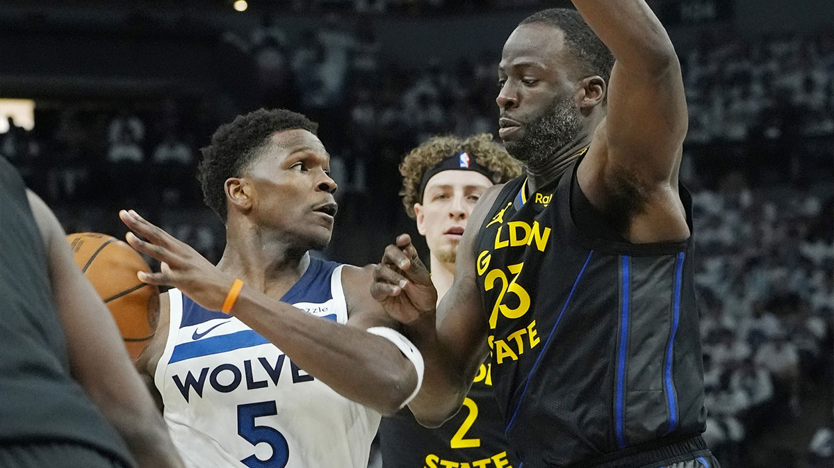 Minnesota Timberwolves guard Anthony Edwards (5) controls the ball against Golden State Warriors forward Draymond Green (23) in the first quarter during game one of the second round for the 2025 NBA Playoffs at Target Center.