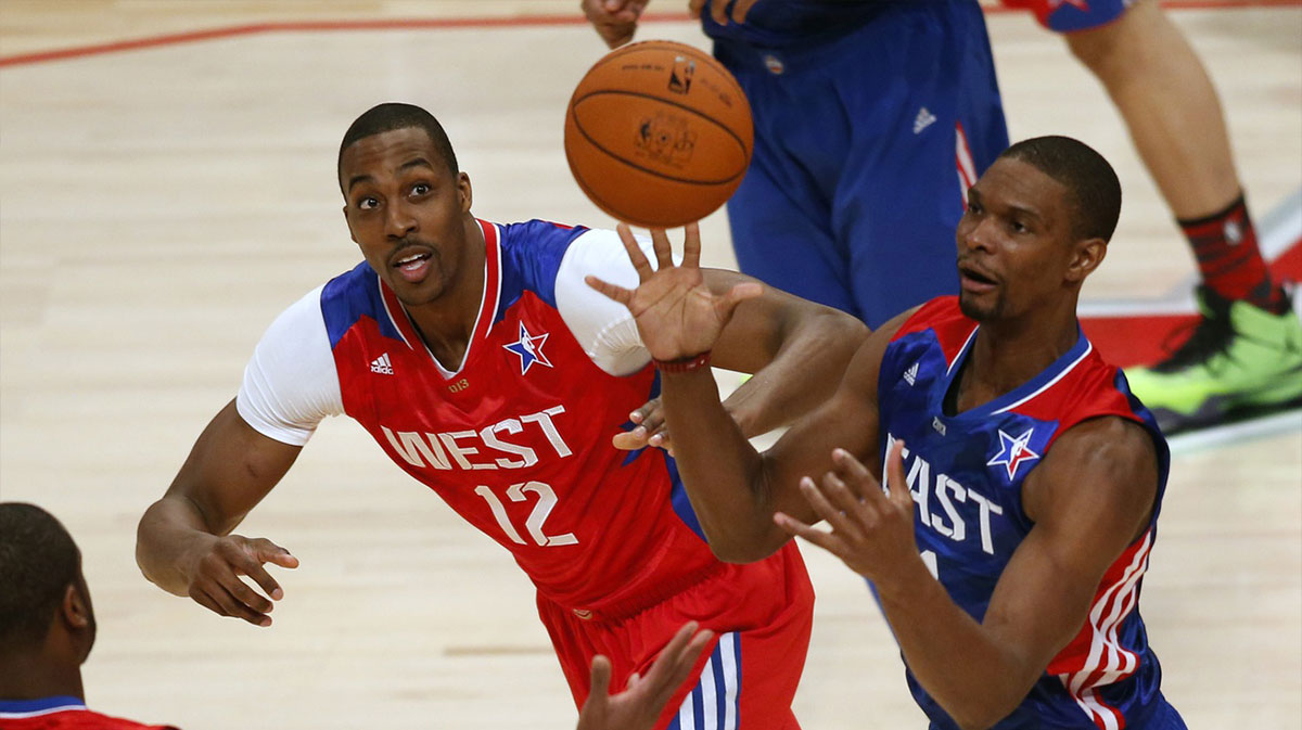 Eastern Conference forward Chris Bosh (1) of the Miami Heat catches a pass against Western Conference center Dwight Howard (12) of the Los Angeles Lakers during the second half of the 2013 NBA All-Star Game at the Toyota Center.