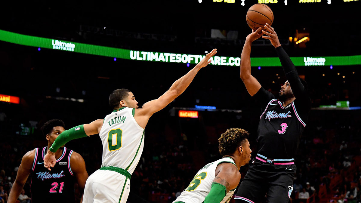 Miami Heat guard Dwyane Wade (3) shoots over Boston Celtics forward Jayson Tatum (0) during the first half at American Airlines Arena.