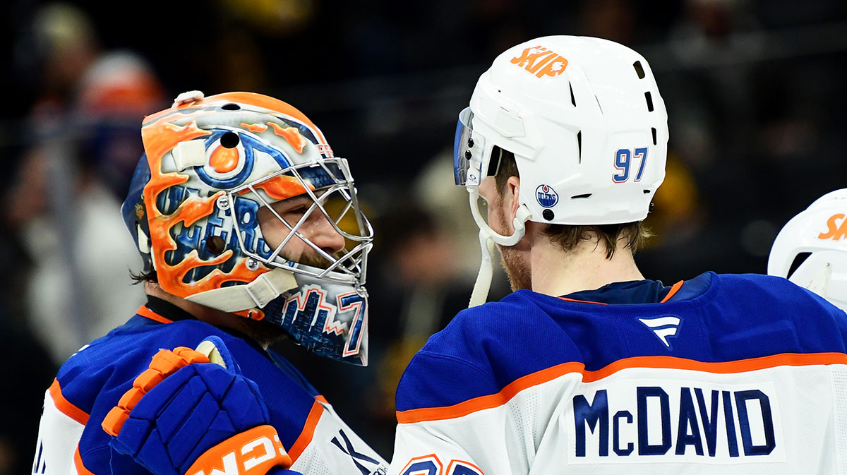 Edmonton Oilers center Connor McDavid (97) congratulates goaltender Stuart Skinner (74) after defeating the Boston Bruins at TD Garden.