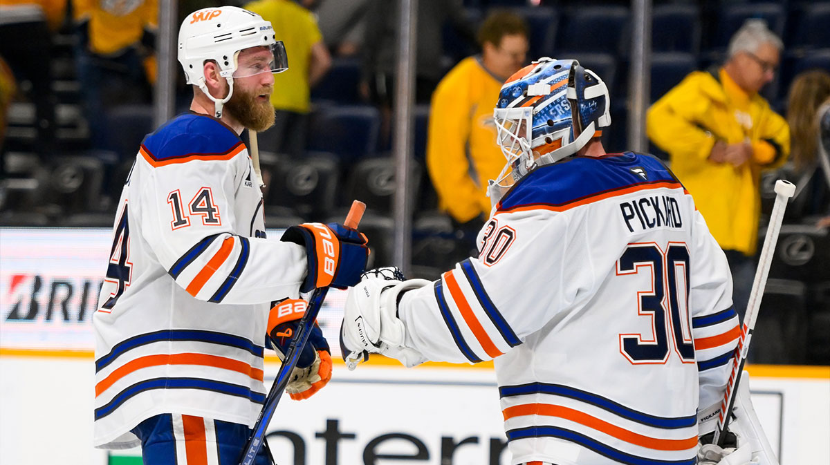 Edmonton Oilers defenseman Mattias Ekholm (14) celebrates the win with goaltender Calvin Pickard (30) during the third period during the third period at Bridgestone Arena.